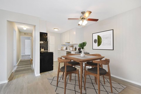 A dining room with a wooden table and chairs.