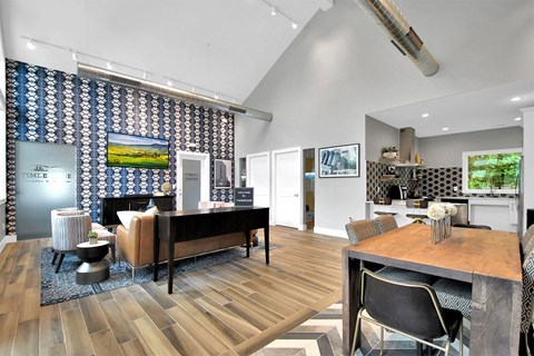 A modern living room with a wooden floor and a dining area.