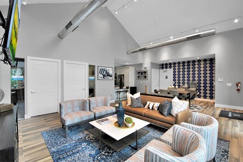 A living room with a white couch and striped chairs.