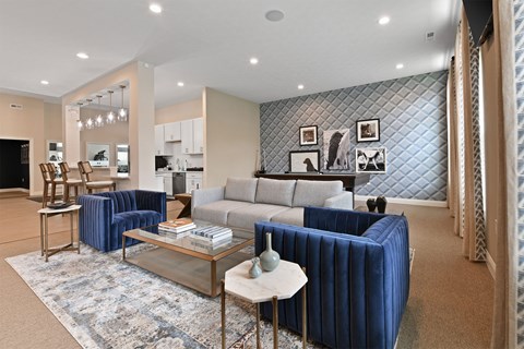 A living room with a blue couch and a coffee table.