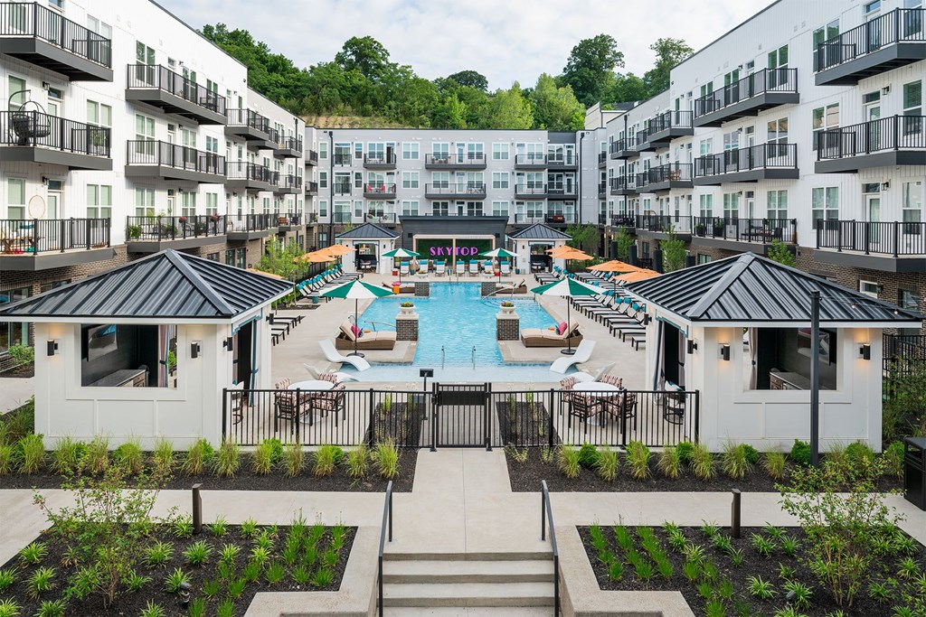 an aerial view of an apartment complex with a swimming pool