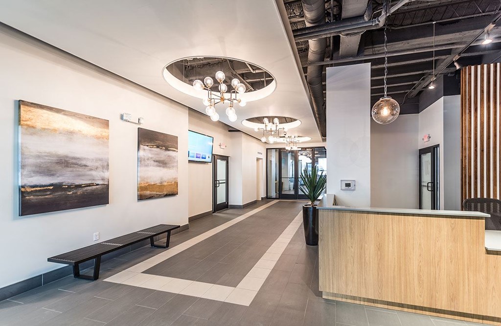 A reception area with a wooden counter and a bench.