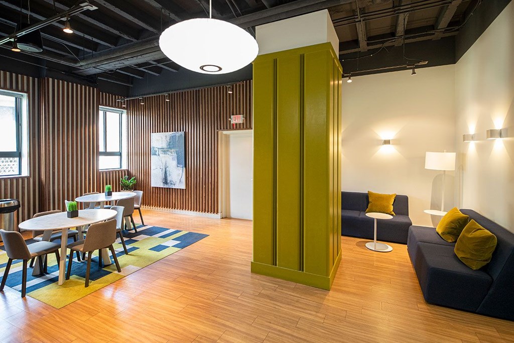A room with a wooden floor and a green cabinet.