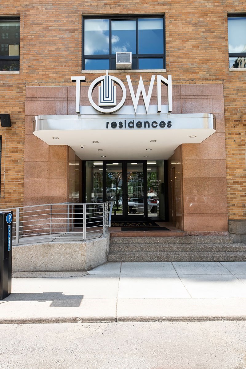 The front of a building with the words "Town Residences" on it.