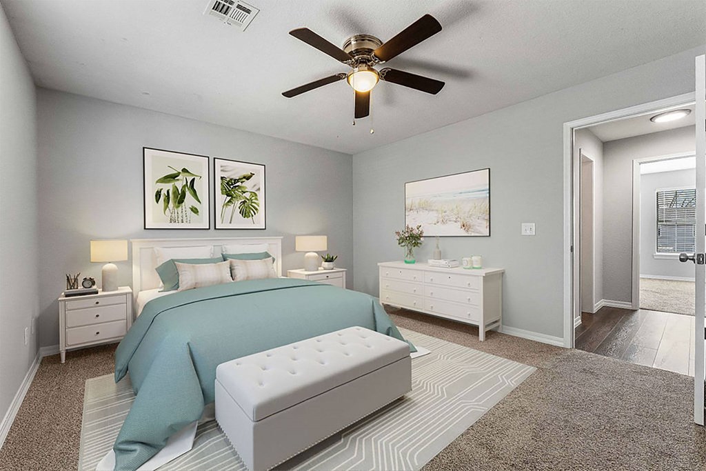 A bedroom with a bed, nightstand, and a ceiling fan.