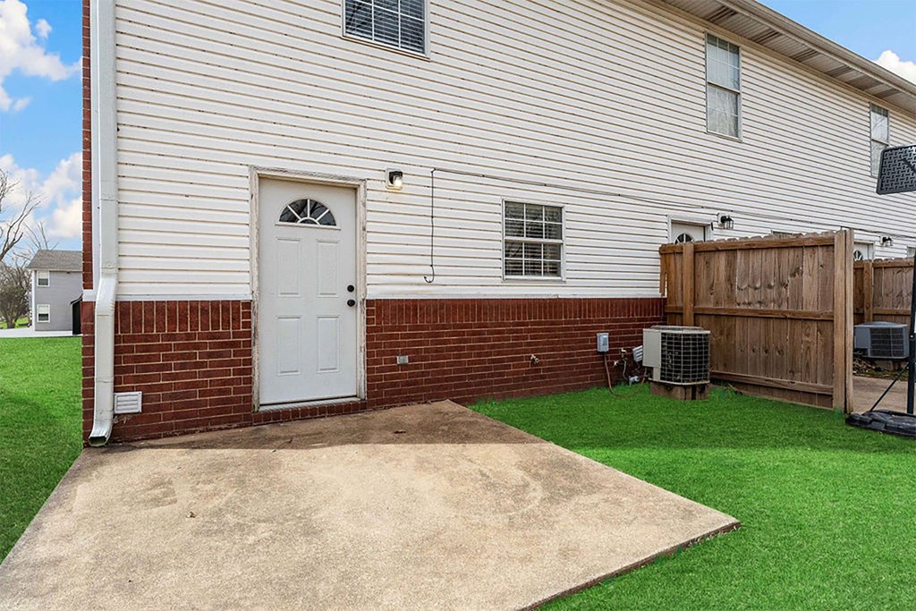 A house with a white door and a brown fence.