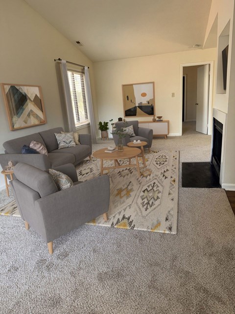 A living room with a grey couch and a coffee table.