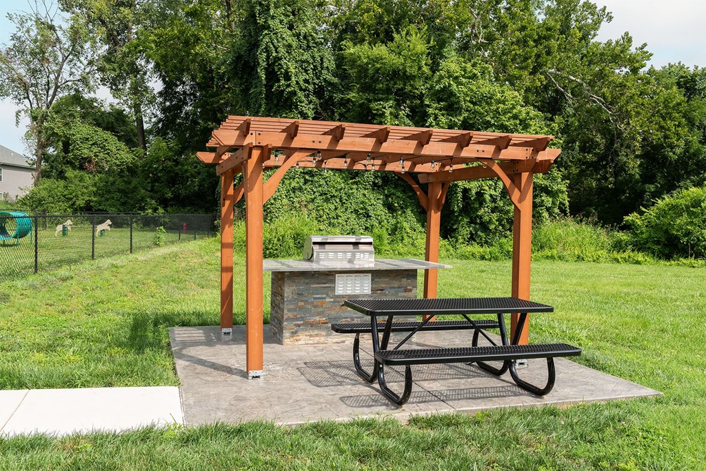 a picnic area with a picnic table and a fire pit