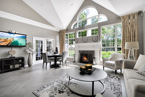 A modern living room with a fireplace and a television.