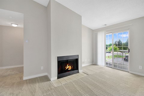 A living room with a fireplace and sliding glass doors.