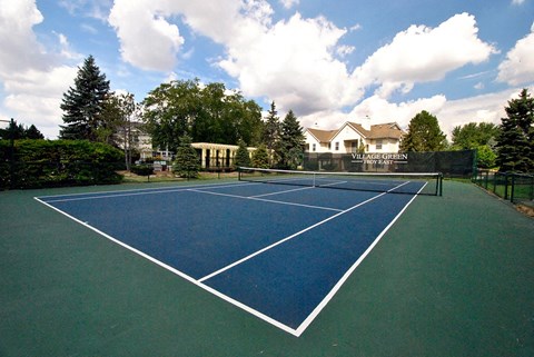 A tennis court with a sign that says "House Garden".