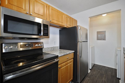 A kitchen with a black refrigerator and stove.