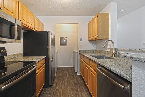 Kitchen with honey oak cabinets and stainless appliances