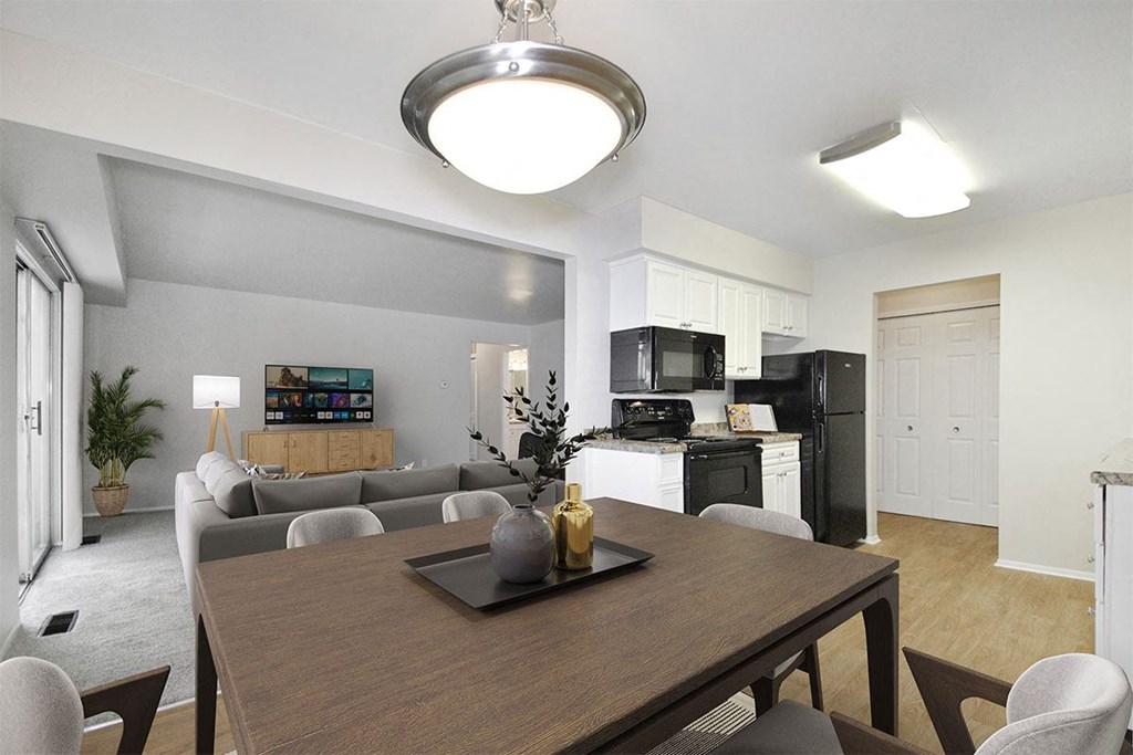 a living room and dining room with a table