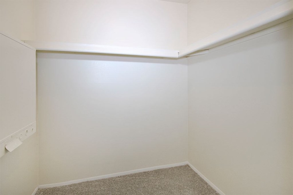 a empty room with white walls and a carpet