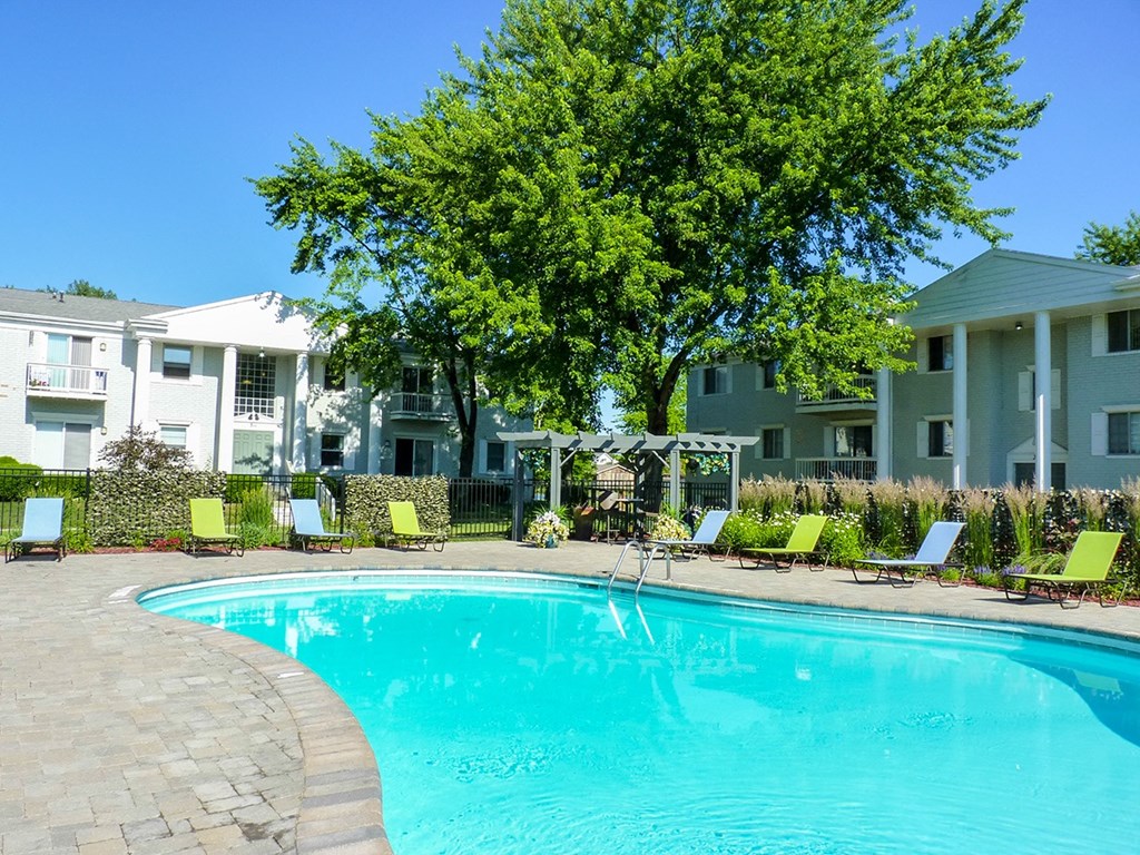 a large swimming pool in front of an apartment building