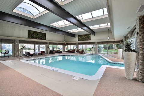 a swimming pool in the middle of a building with windows