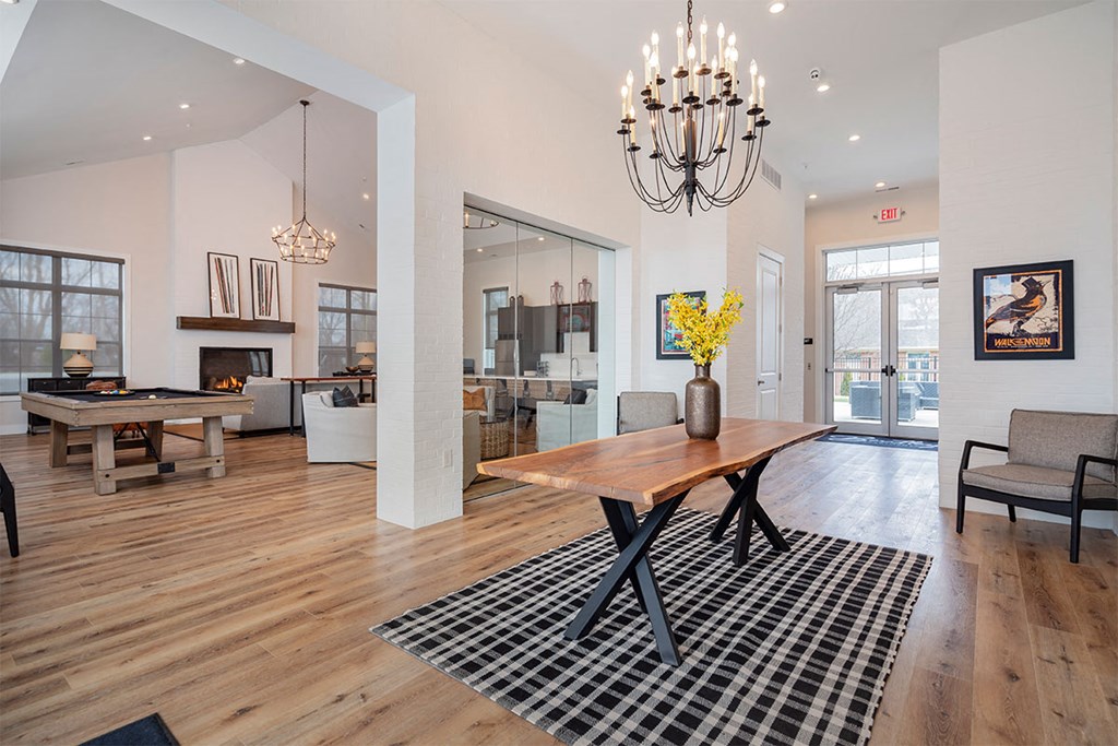 a dining room with a wooden table and a checkered rug