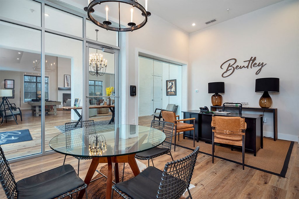 a dining room with a glass table and chairs