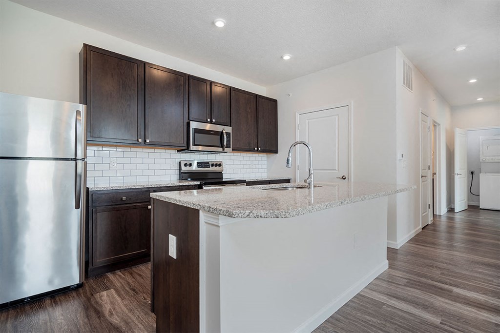 a kitchen with a counter top and a refrigerator