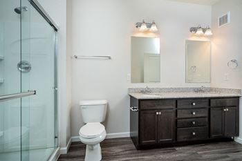 a bathroom with a toilet and a sink and a shower