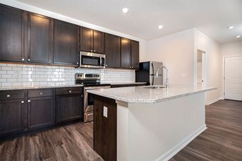 a kitchen with black cabinets and a white counter top