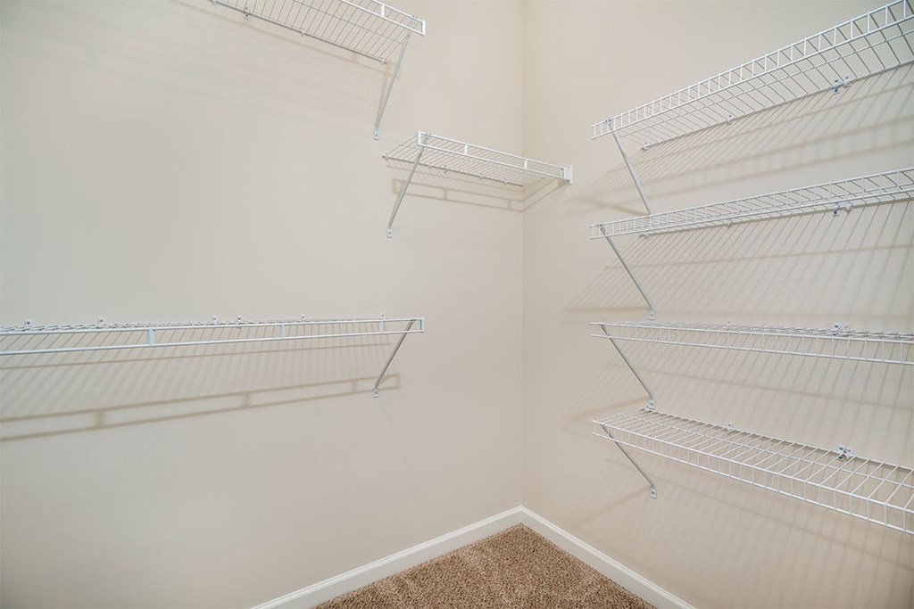 a spacious closet with shelves in a small room