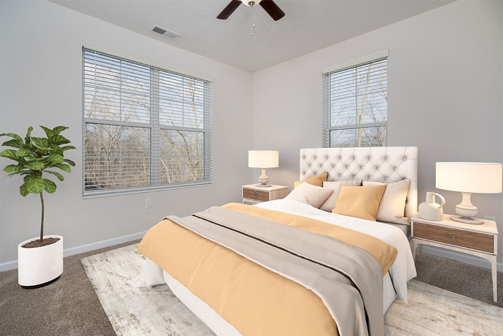 a bedroom with a bed and a ceiling fan
