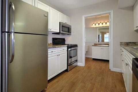 a kitchen with stainless steel appliances and white cabinets