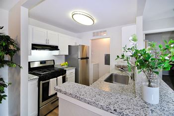a kitchen with granite counter tops and stainless steel appliances