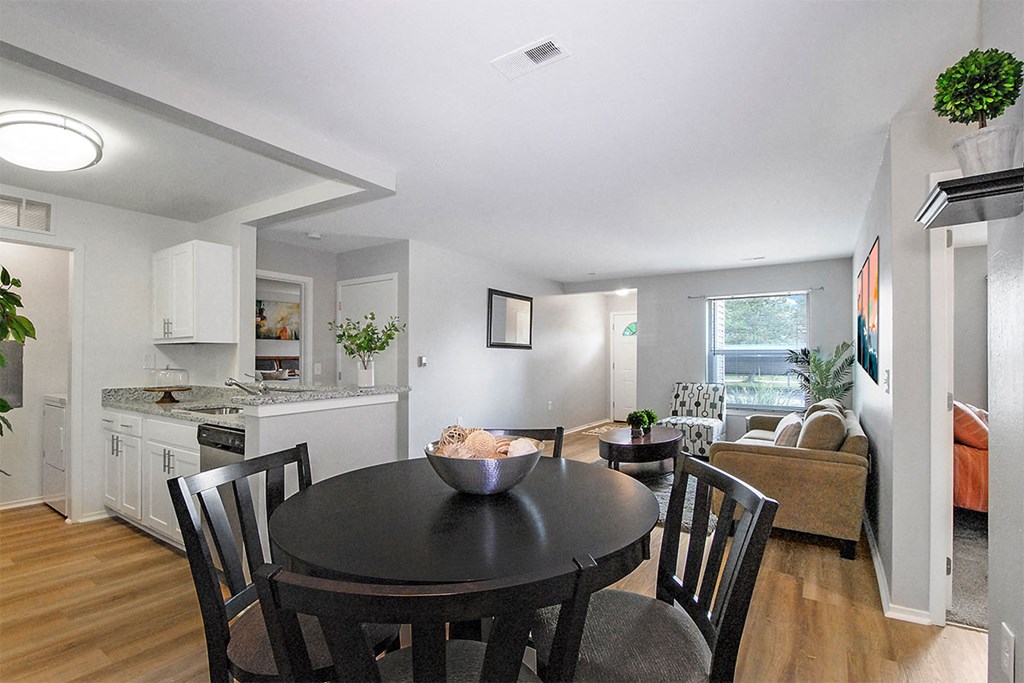 a kitchen and dining room with a table and chairs