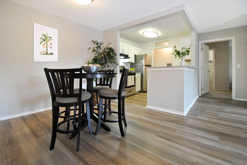 a kitchen and dining room with a table and chairs