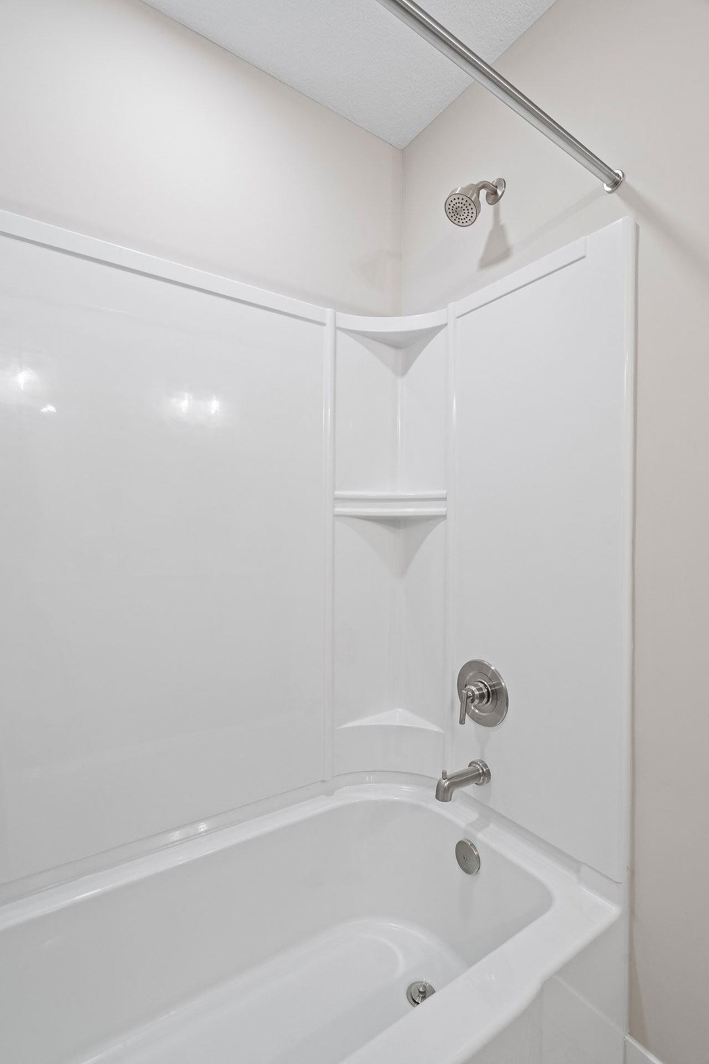 a white bathroom with a shower and a tub