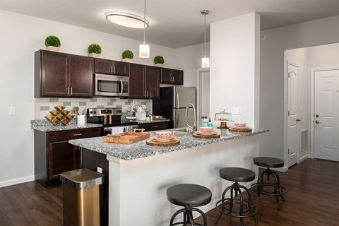 a kitchen with a counter and stools