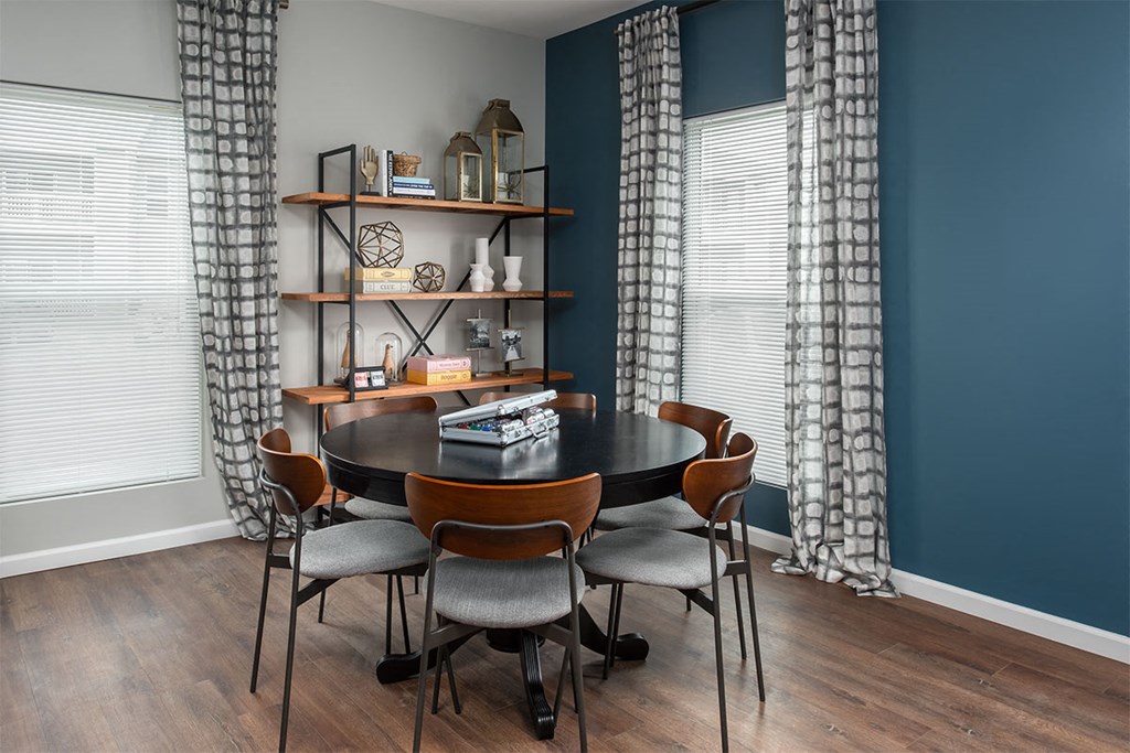 a dining room with a table and chairs