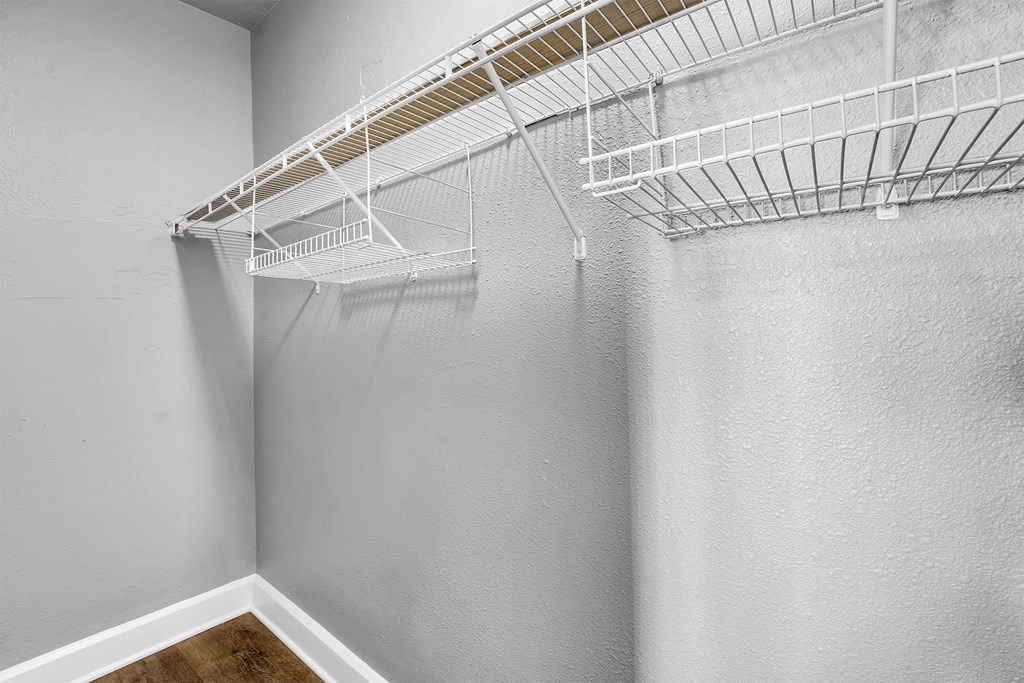 Empty white shelves on a wall.