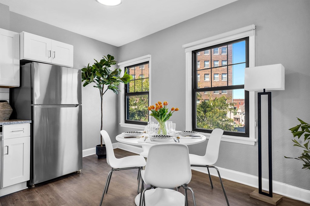 A modern kitchen with a dining table set for two.