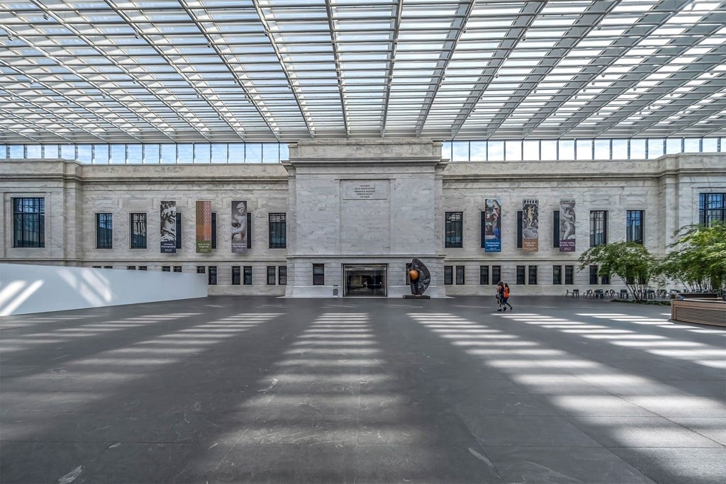 A large open space with a person walking in the middle.