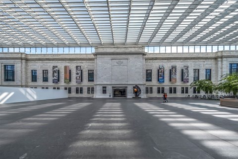 A large open space with a person walking in the middle.