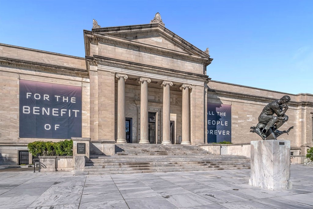 A large building with a banner that says "For the Benefit of All the People Forever".