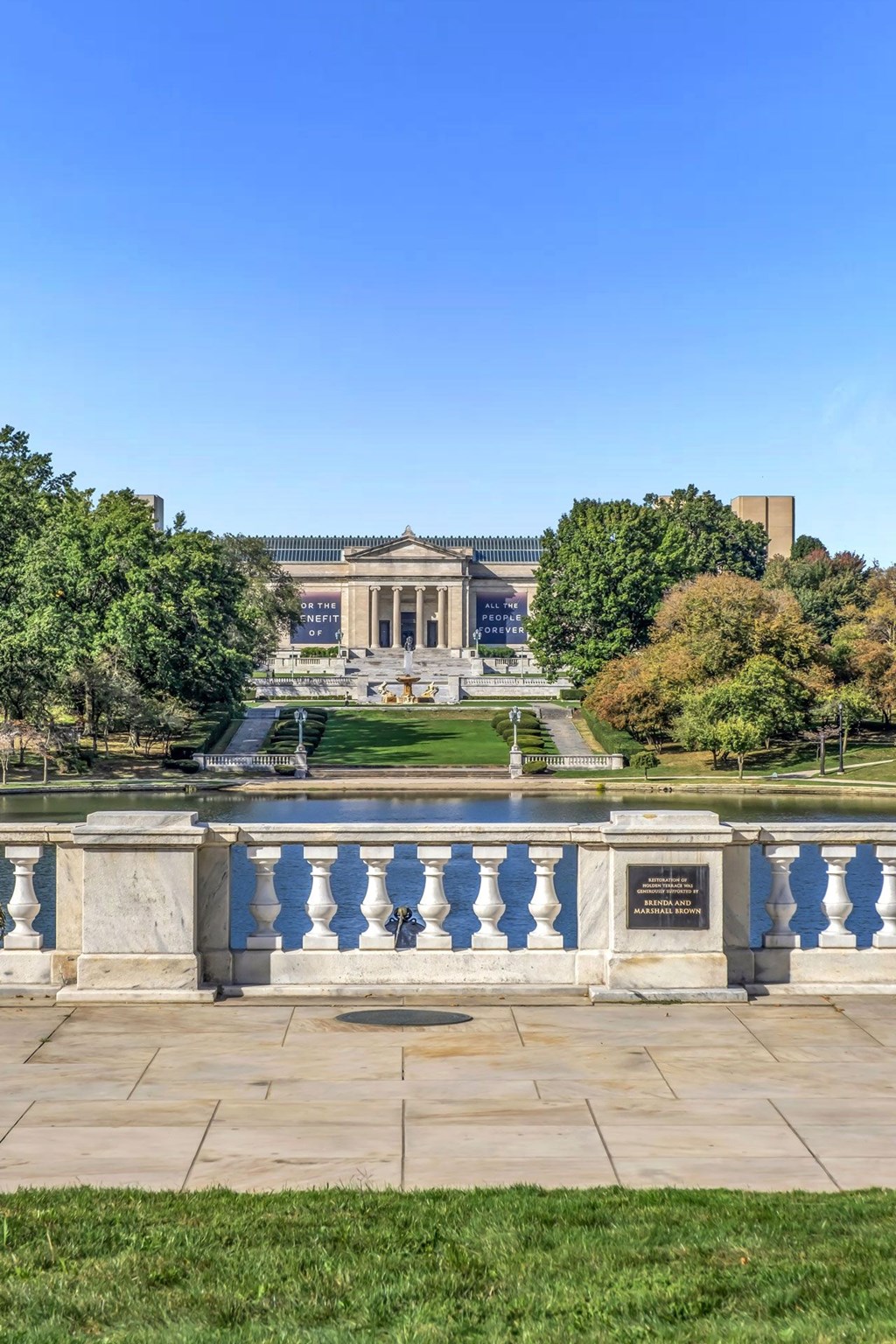 A building with a fountain in front of it.