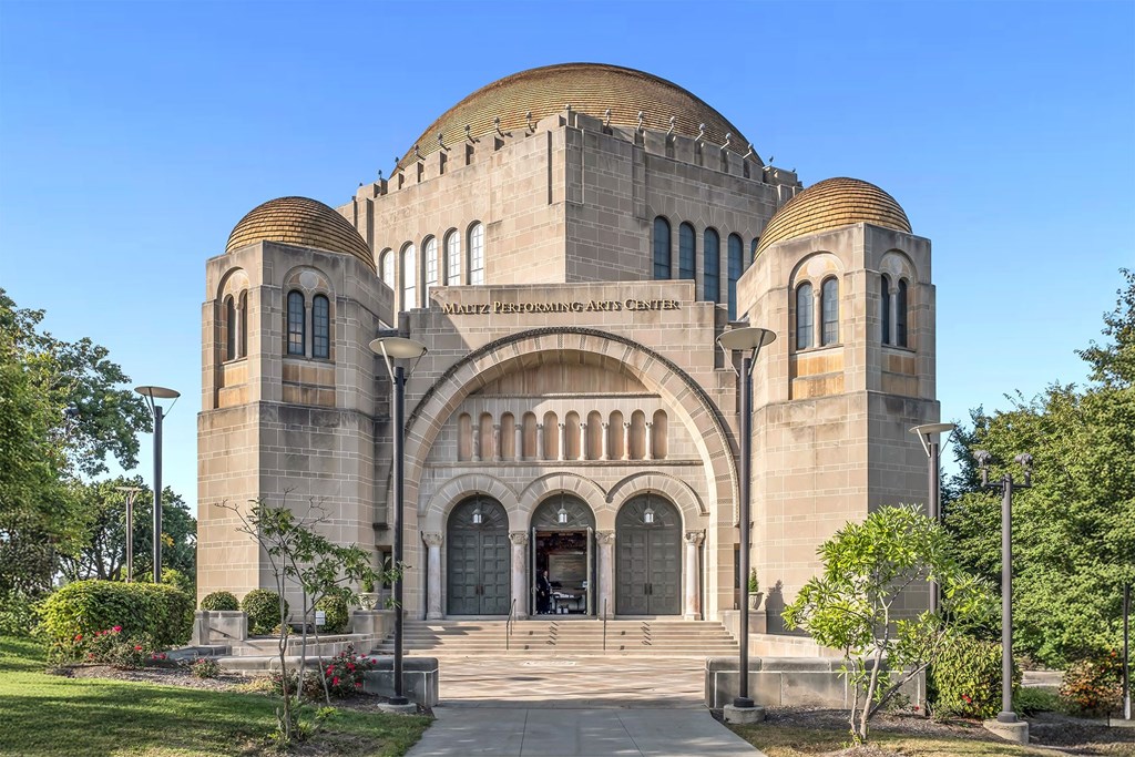 The entrance to a building with a dome and arched doorway.