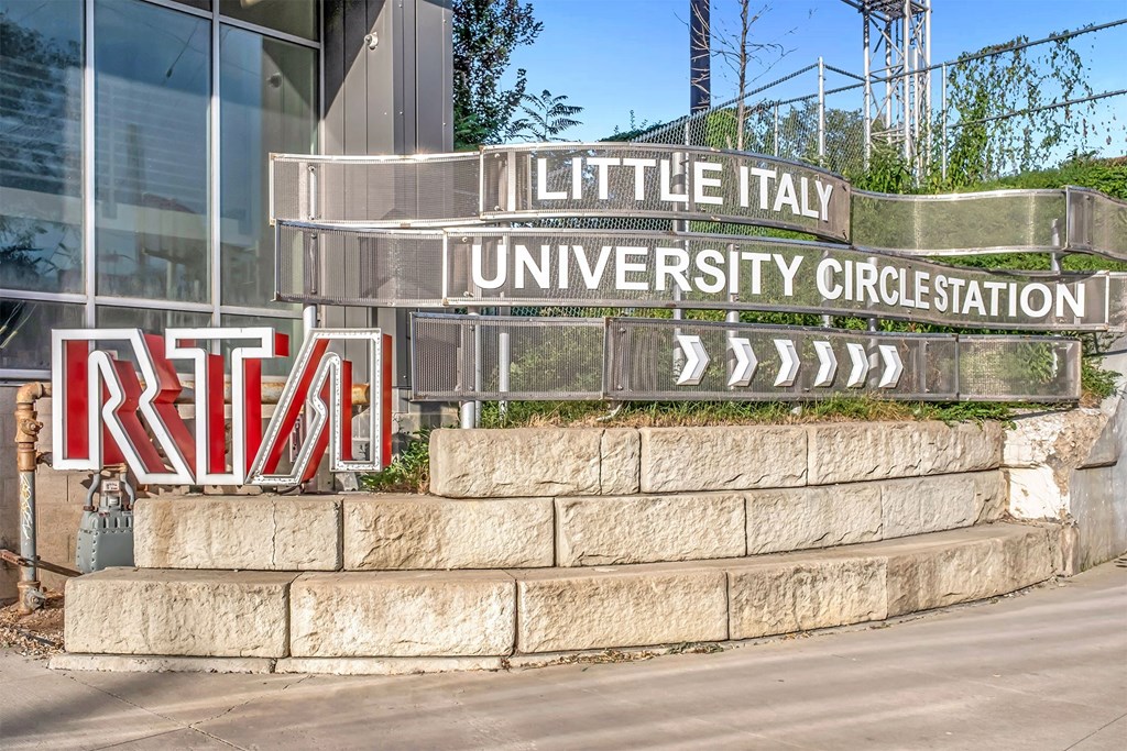 A sign for Little Italy University Circus Station is displayed in front of a building.