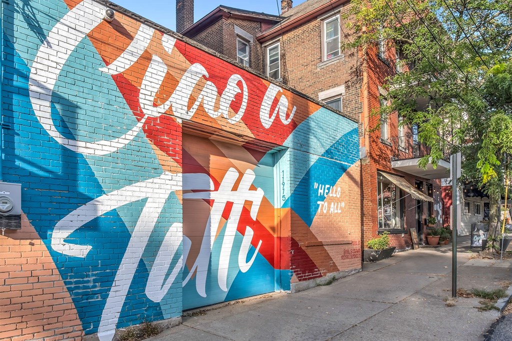 A wall with a mural that says "Hello" in white letters.