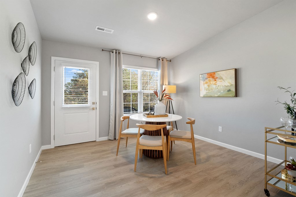 the dining room of a home with a table and chairs