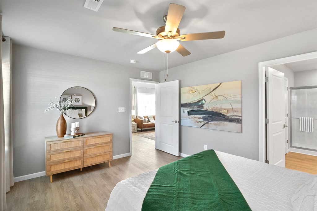 a bedroom with a bed and a ceiling fan