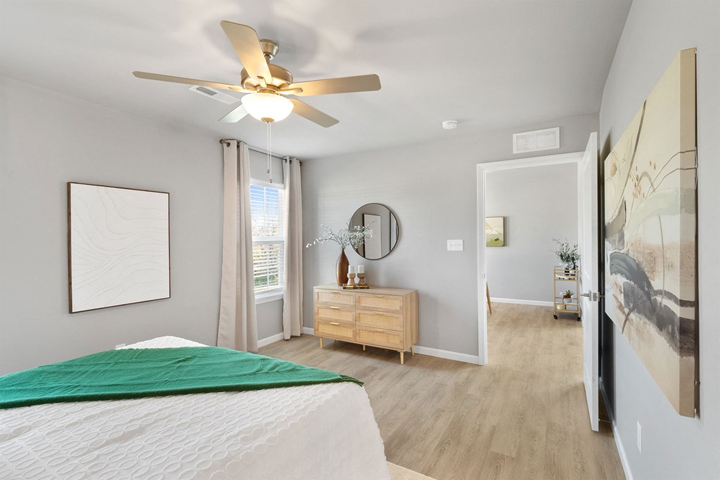 a bedroom with a bed and a ceiling fan