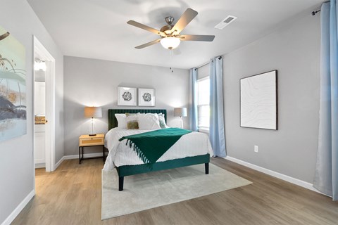 a bedroom with a bed and a ceiling fan