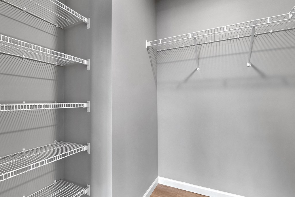 a spacious walk in closet in a home with empty shelves