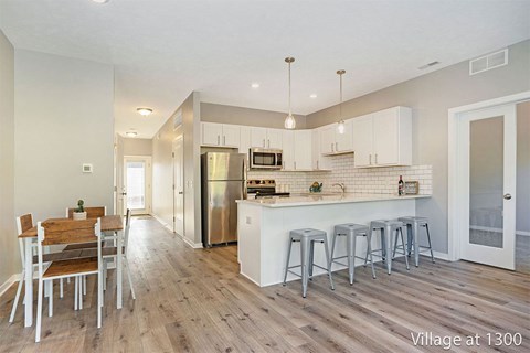 A kitchen with a dining table and chairs in a modern style.